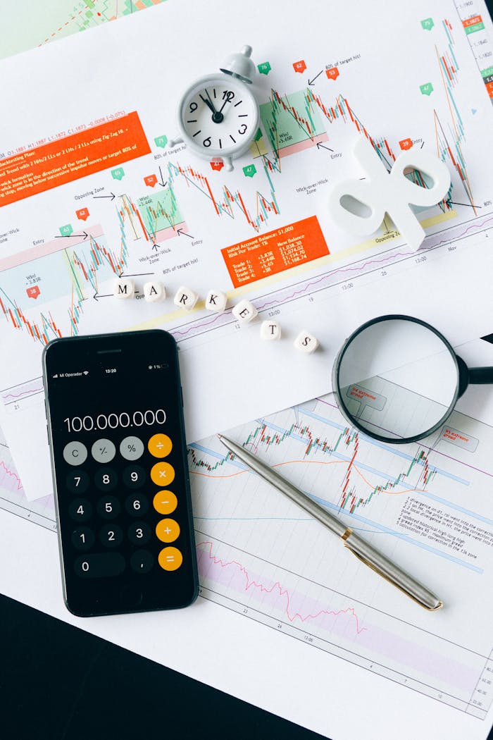 hero-img Flat lay of charts, calculator, and magnifying glass on office desk for market analysis.